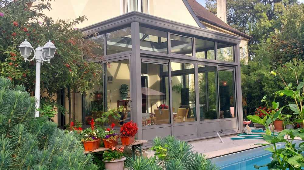 Entrée moderne d'une maison contemporaine avec porte d'entrée en bois massif à panneaux horizontaux, mur d'accent en briques apparentes, fenêtre à lames orientables noires